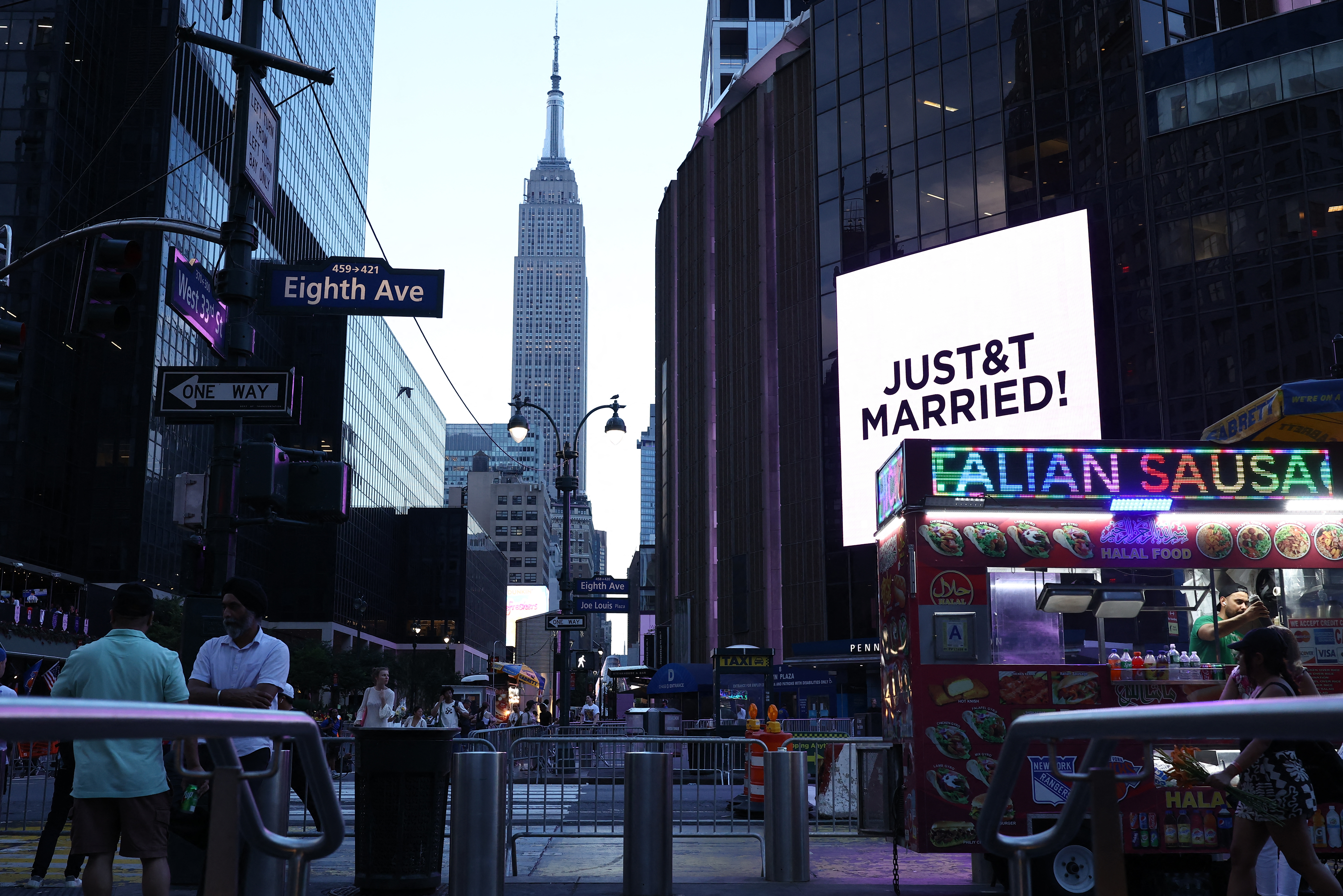 A giant screen outside Madison Square Garden in New York City displays "JUST&T MARRIED!" for Taylor Swift and Travis Kelce.