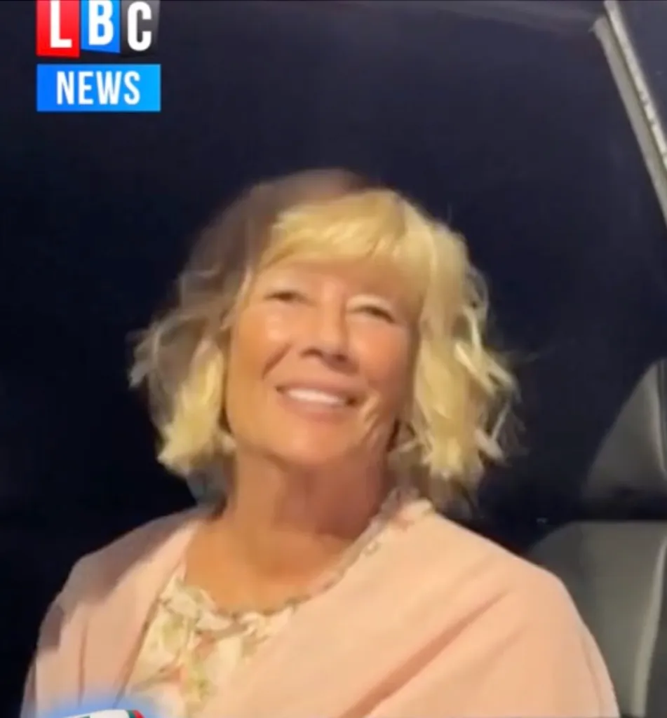 Taylor Swift's aunt, Robin, smiling while sitting in a car.