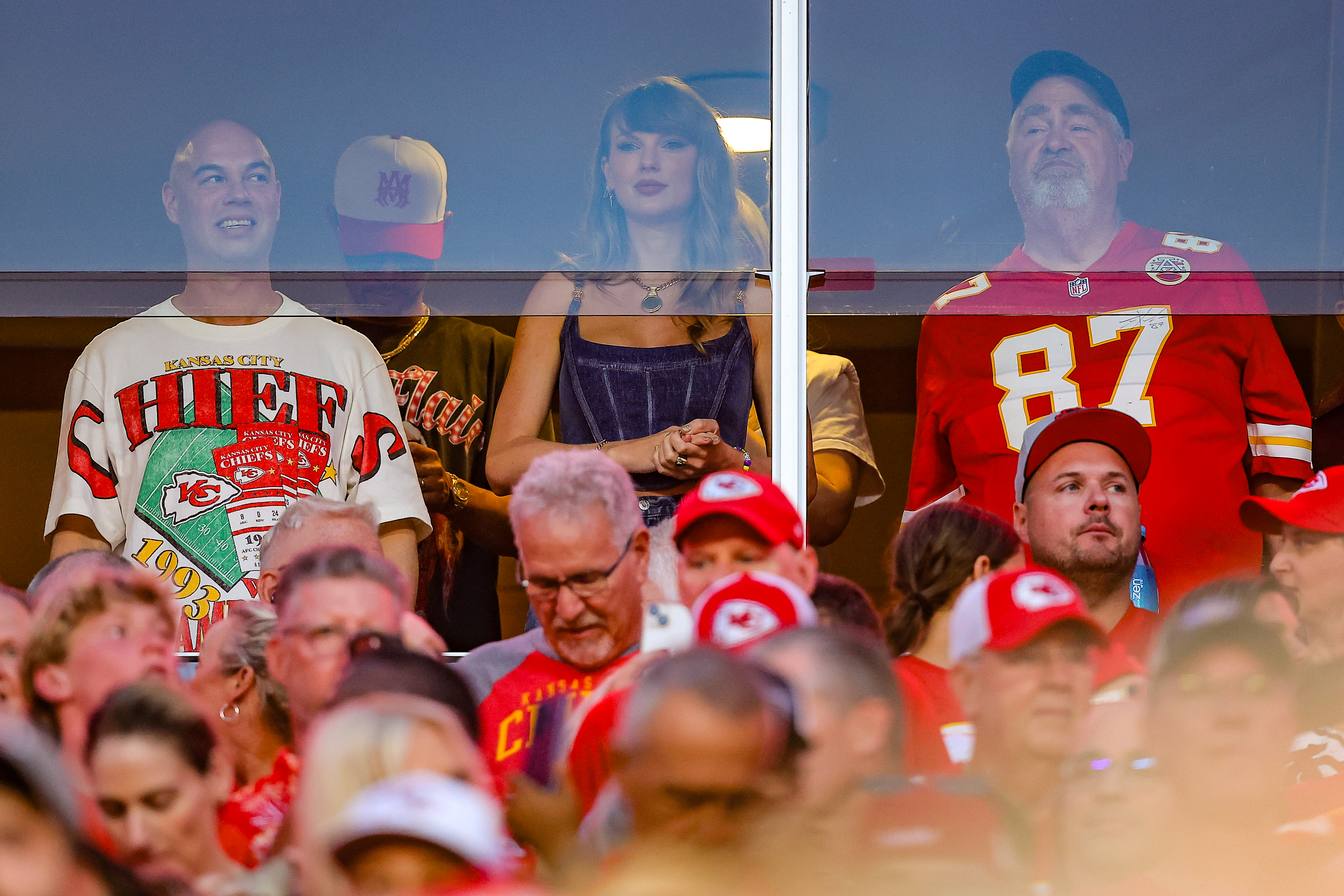 Taylor Swift watches a game with Travis Kelce's father, Ed Kelce, and others from a suite.