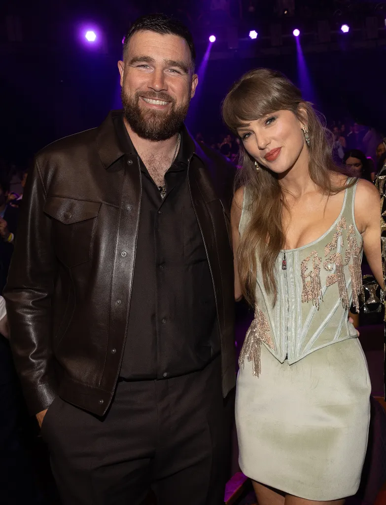 Taylor Swift and Travis Kelce posing at the iHeartRadio Music Awards.