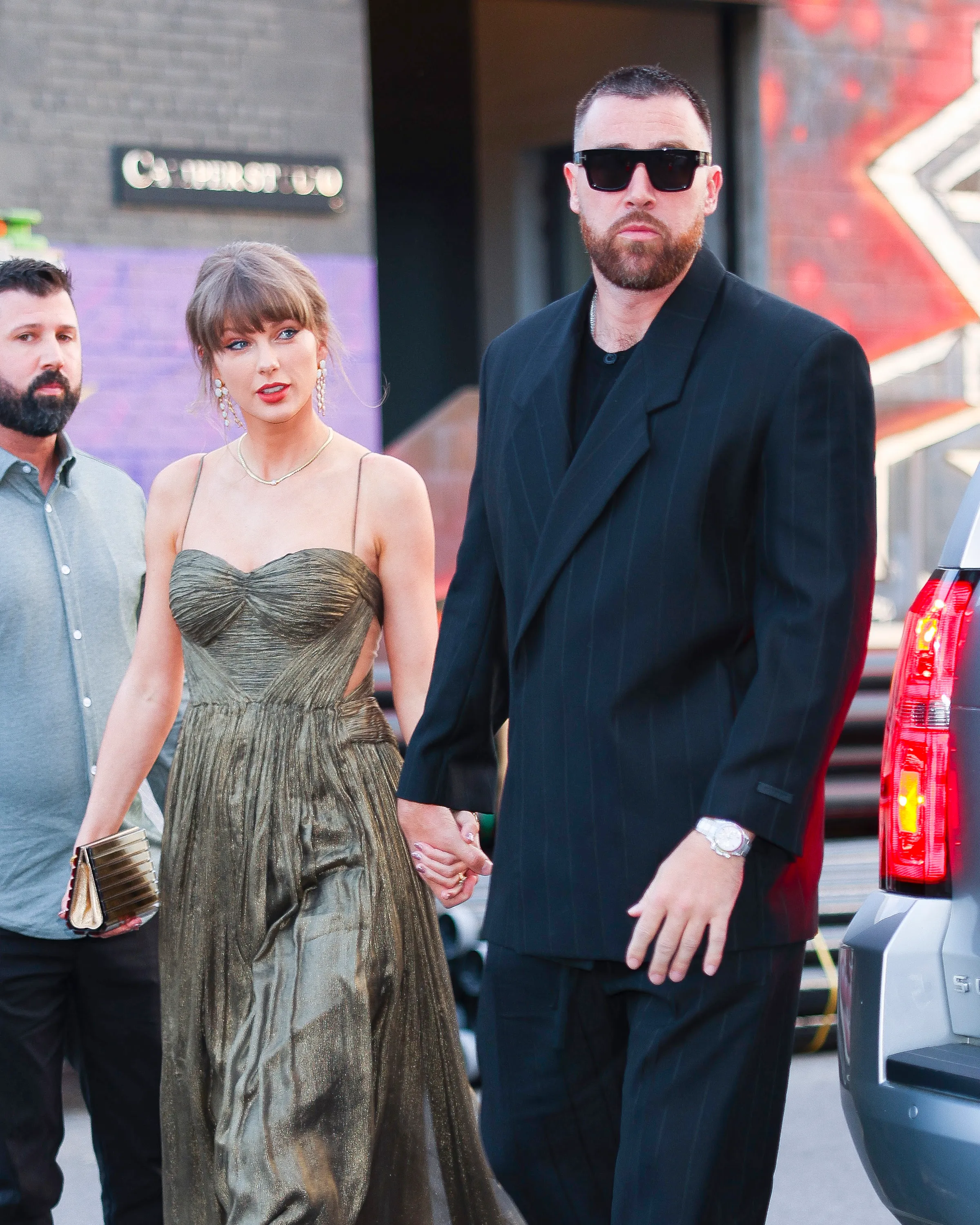 Taylor Swift and Travis Kelce holding hands while walking in Brooklyn.