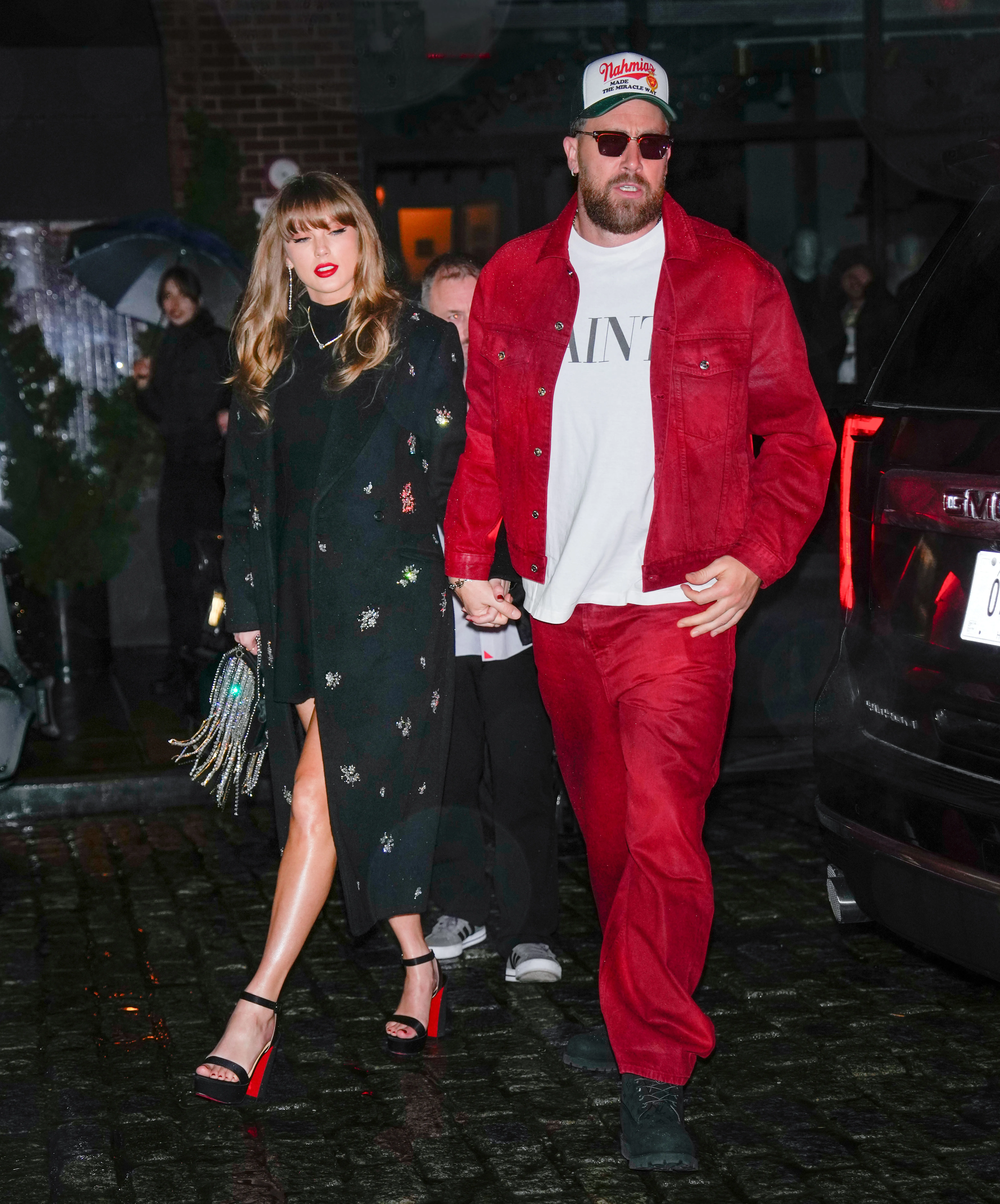 Taylor Swift and Travis Kelce walking hand-in-hand in New York City.