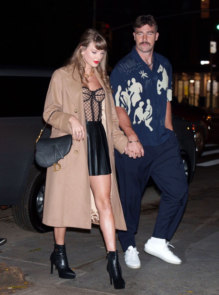 Taylor Swift and Travis Kelce walking hand-in-hand in New York City.