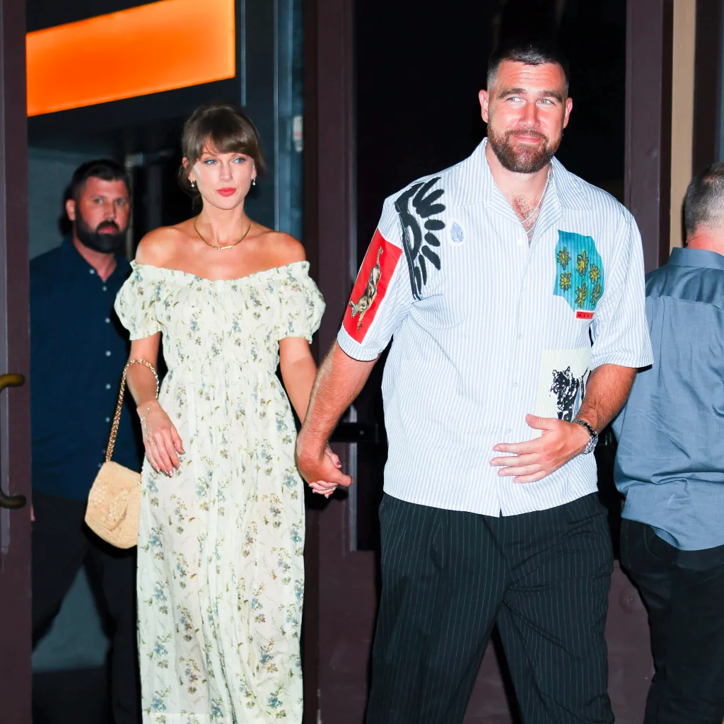 Taylor Swift and Travis Kelce holding hands while leaving Zero Bond.