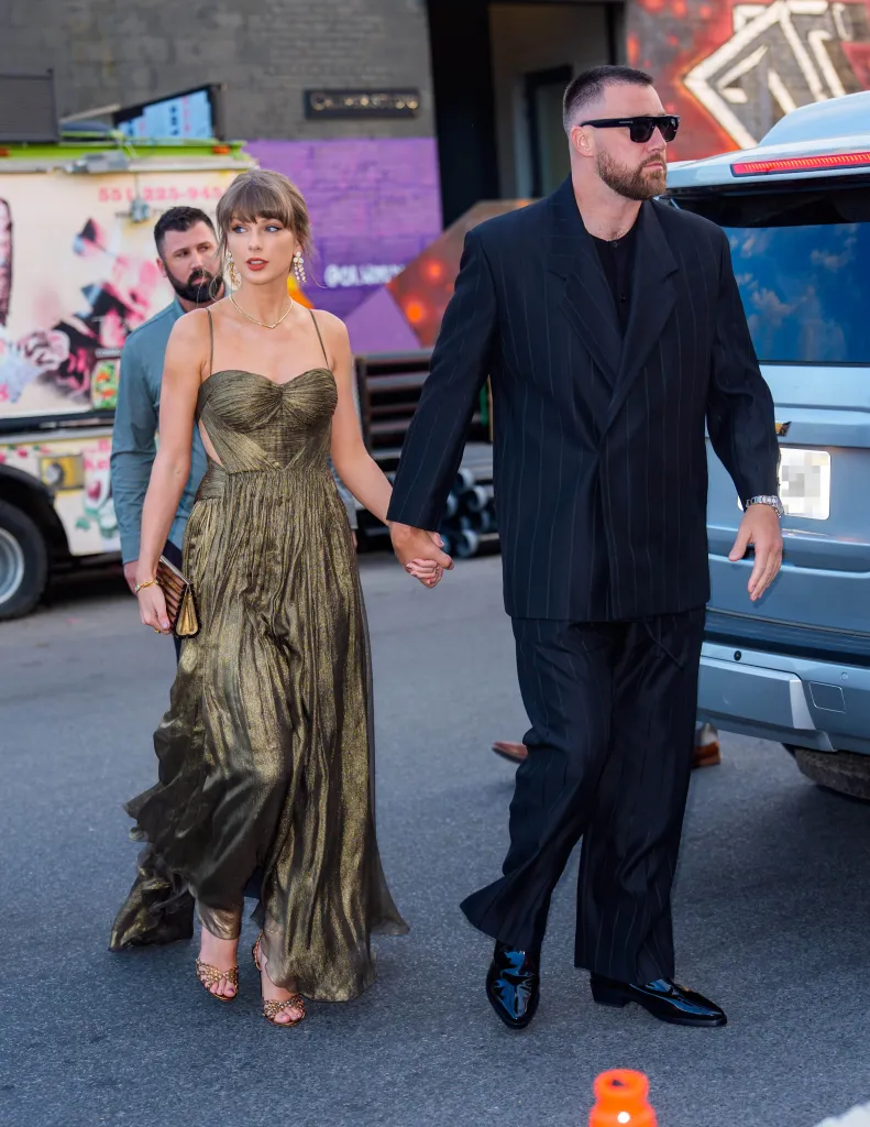 Taylor Swift and Travis Kelce holding hands while walking in New York City.