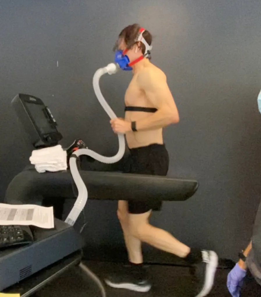 Bryan Johnson on a treadmill wearing a mask and heart monitor for a health experiment.