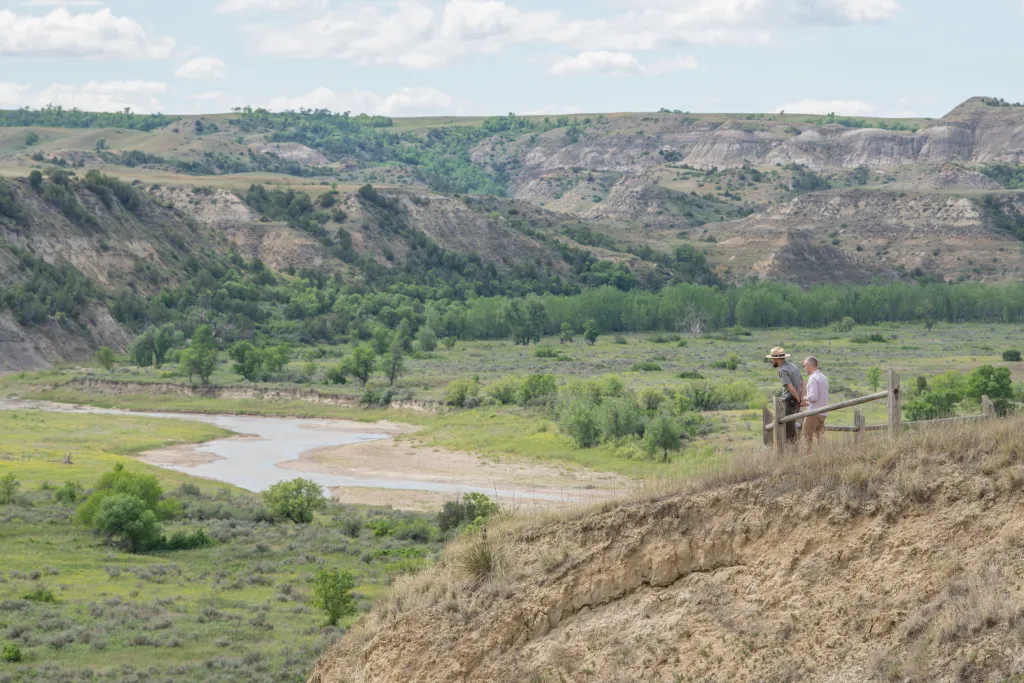 Two men looking out over a river valley in Teddy Roosevelt National Park.