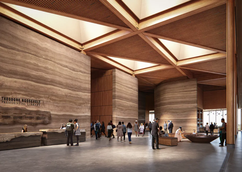 Illustration of the Theodore Roosevelt Presidential Library with visitors, showcasing a large hall with textured walls and a wooden beamed ceiling.