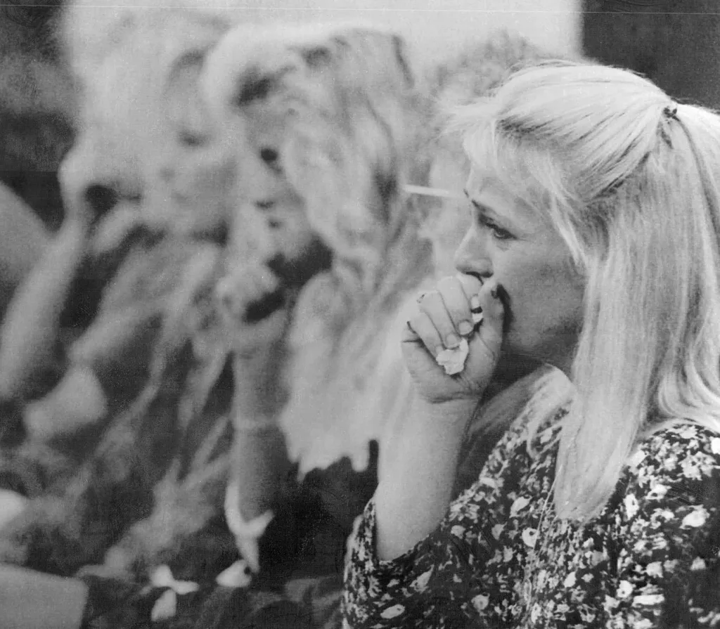 Sherry Massengill cries while holding a tissue to her face.