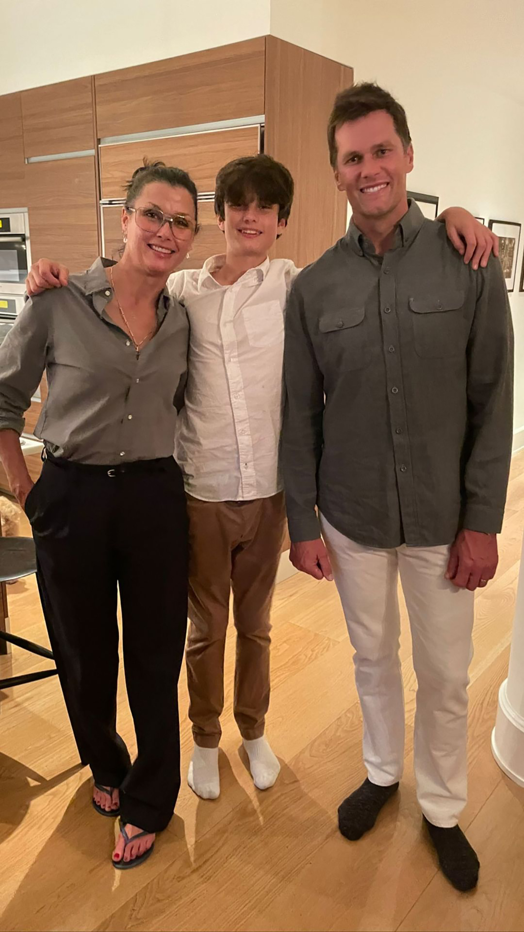 Bridget Moynahan, her son Jack, and Tom Brady posing for a photo.