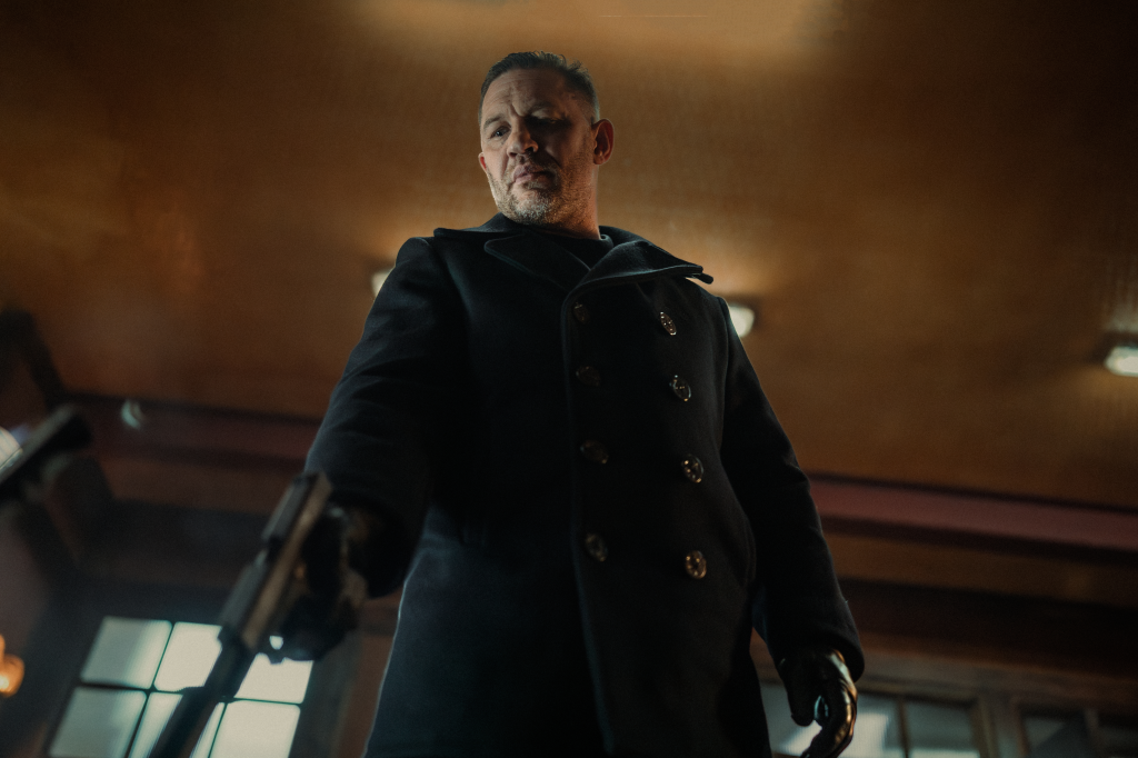 Tom Hardy as Harry Da Souza holding a gun in Mobland.