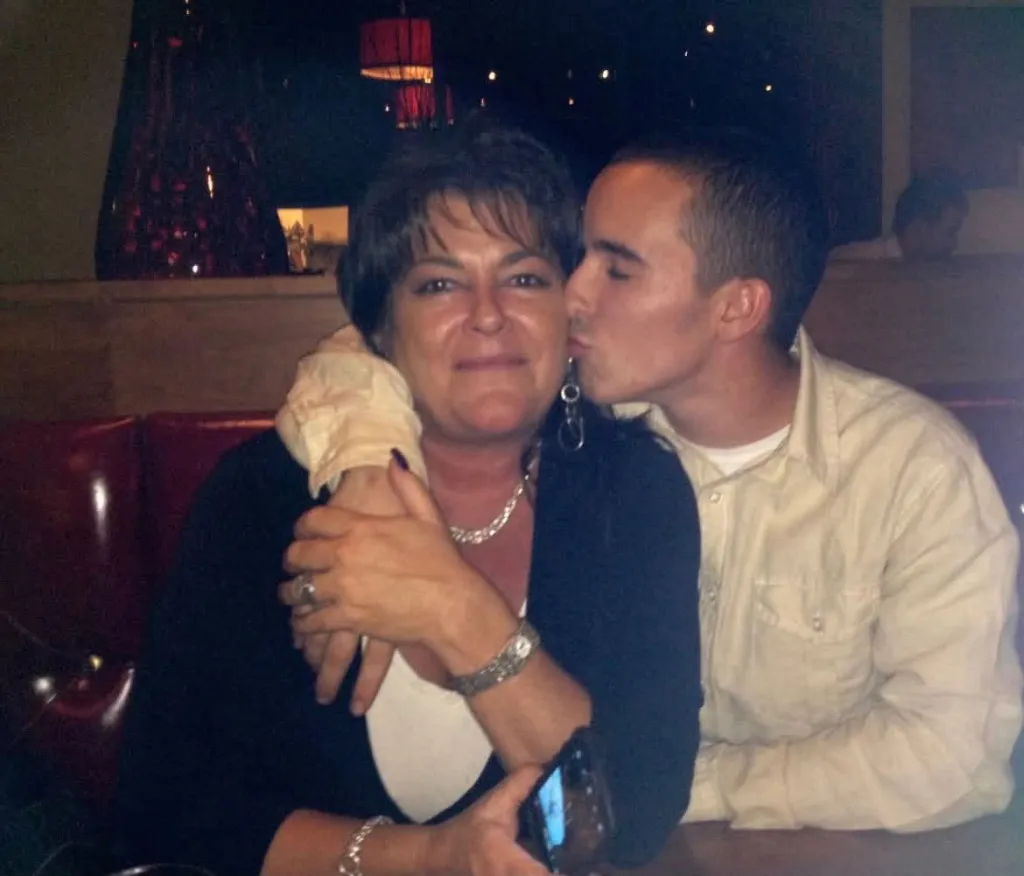 Tondra Madruga with her brother, Quin Madruga, who is kissing her cheek.