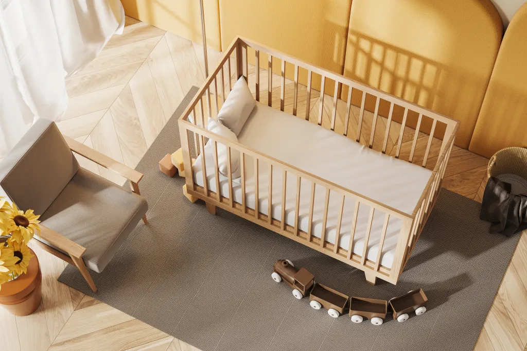 Illustration of a baby room with a crib, armchair, and rug, top-view.
