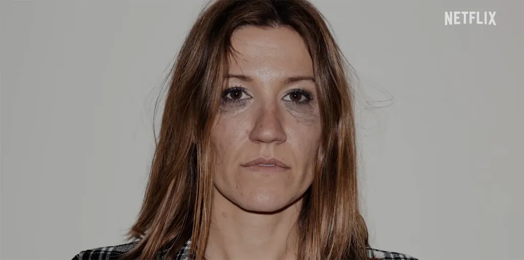 Woman with smudged eye makeup looking directly at the camera, with the Netflix logo in the top right.