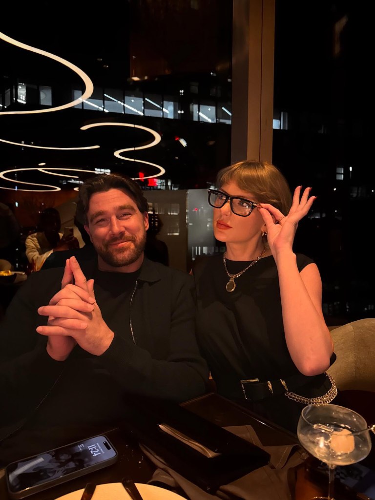 Travis Kelce and Taylor Swift smiling while having dinner.