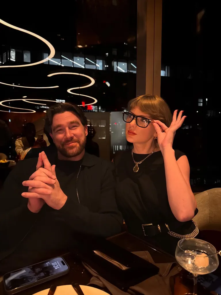 Travis Kelce and Taylor Swift at a restaurant.