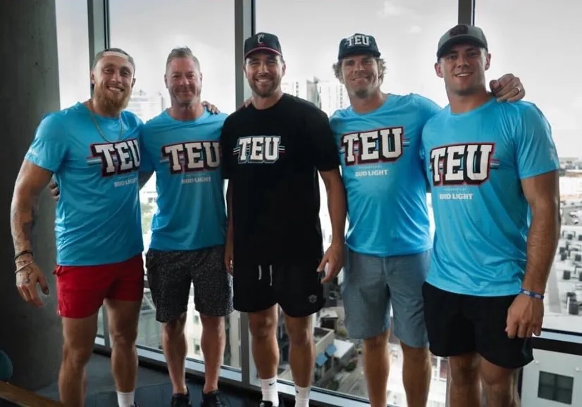 George Kittle, Jeremy Shockey, Travis Kelce, Greg Olsen, and Brock Bowers posing together at a Tight End University event.
