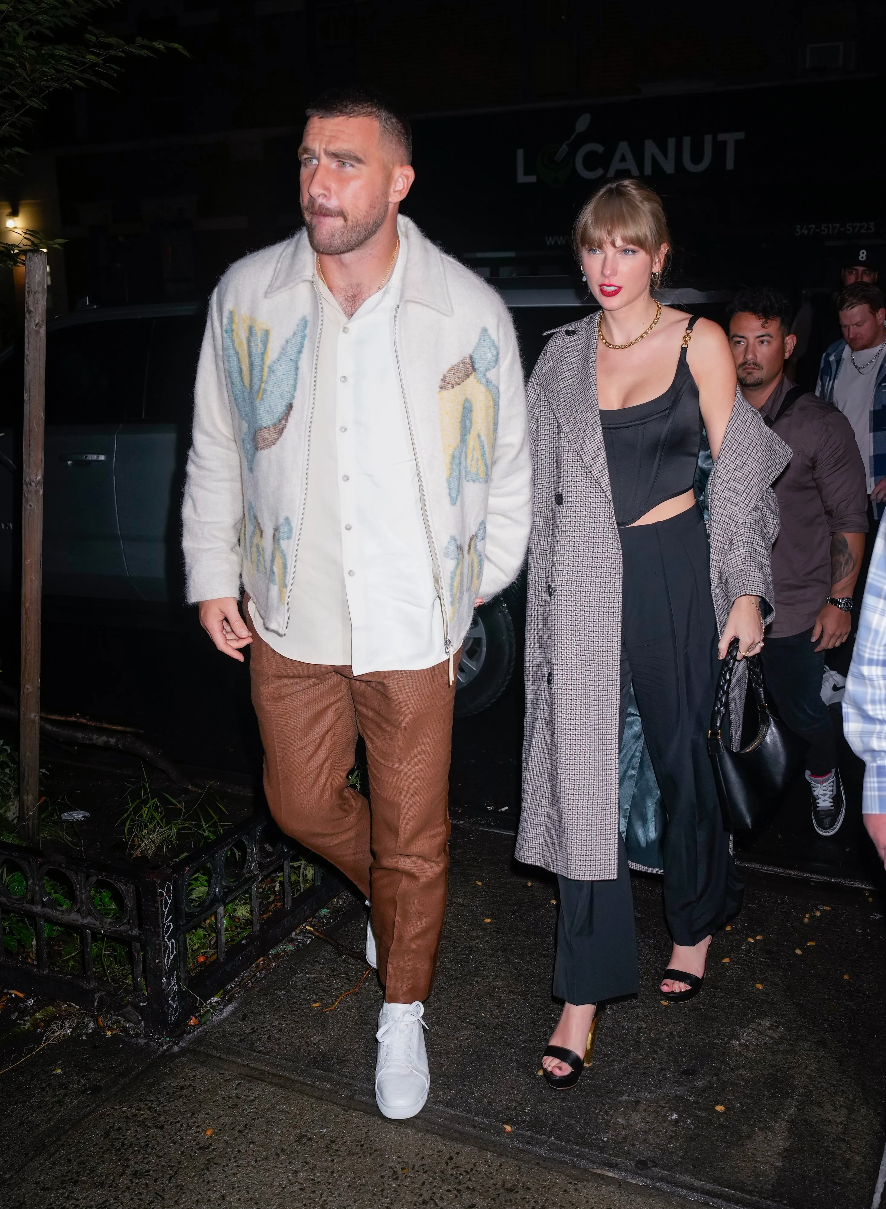 Travis Kelce and Taylor Swift arriving at an SNL afterparty.
