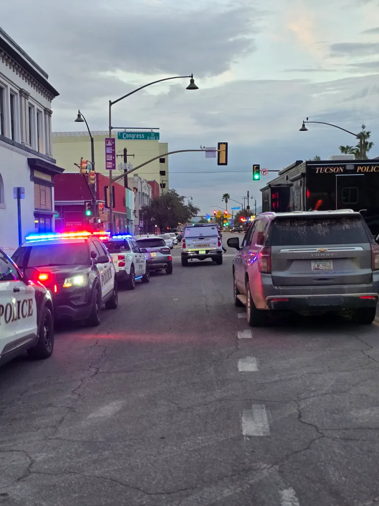 Police and forensics vehicles on Congress Street in Tucson.