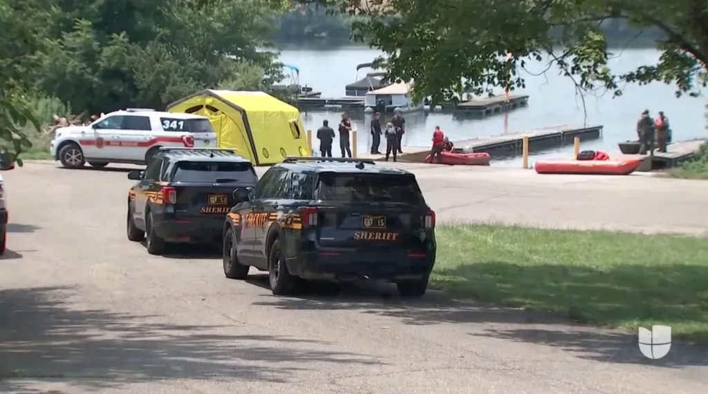 Rescue crews search for the bodies of the drowned boaters on the Scioto River.