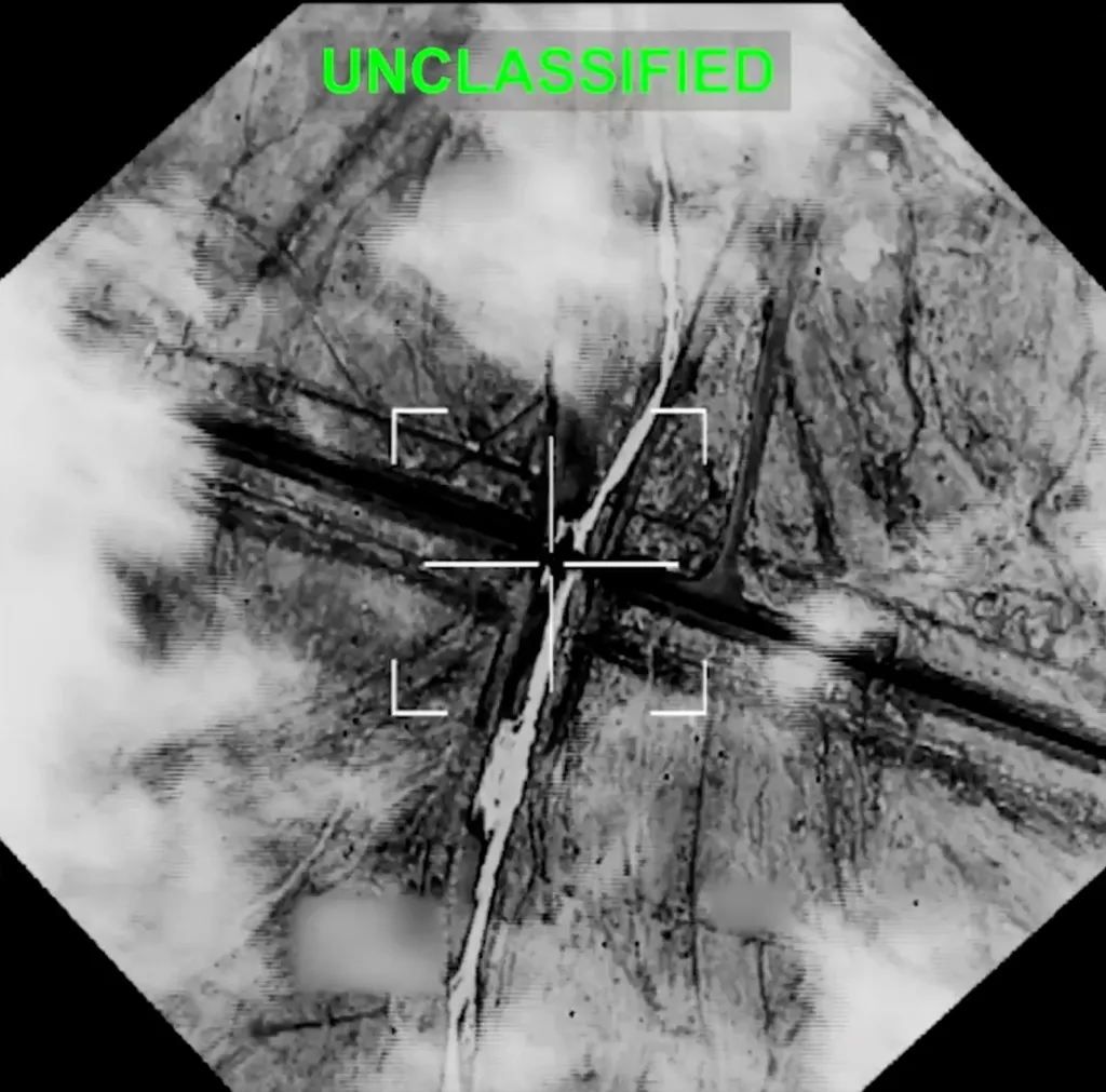 Aerial image of a target with a crosshair and "UNCLASSIFIED" text overlay.