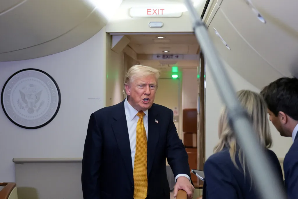 U.S. President Donald Trump speaks to reporters in the press cabin of Air Force One.