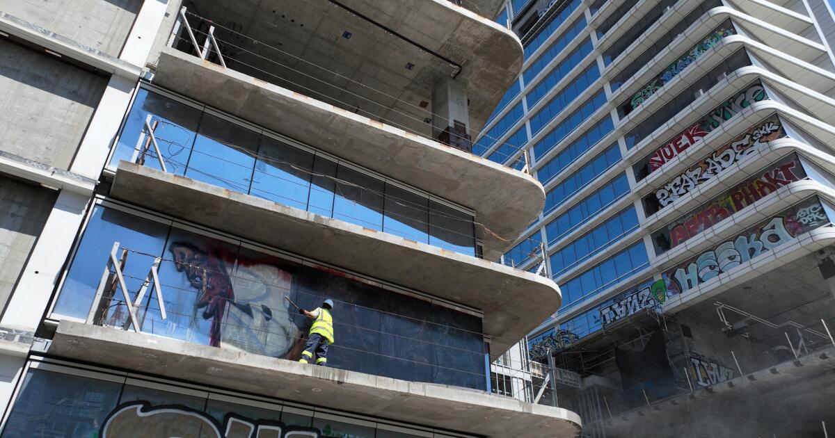 Graffiti towers clean-up begins