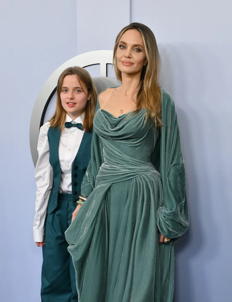 Angelina Jolie and daughter Vivienne Jolie-Pitt, both in teal, pose for a vertical shot.