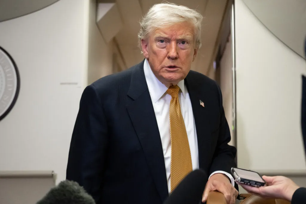 US President Donald Trump speaks to the media aboard Air Force One.