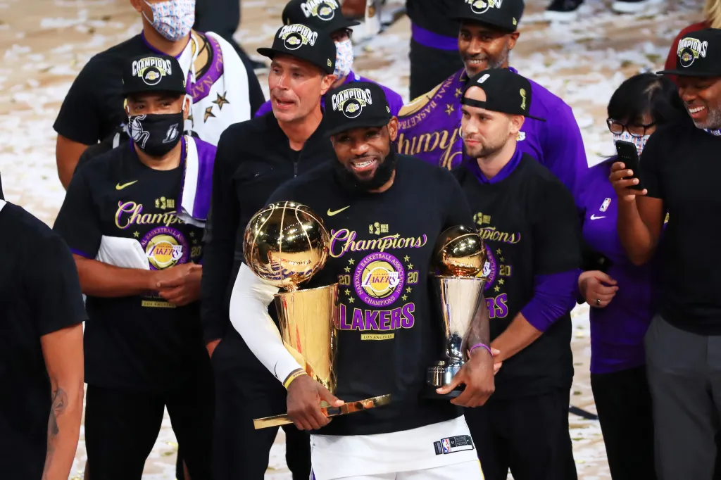 LeBron James of the Los Angeles Lakers celebrates with his MVP trophy and Finals trophy after winning the 2020 NBA Championship.