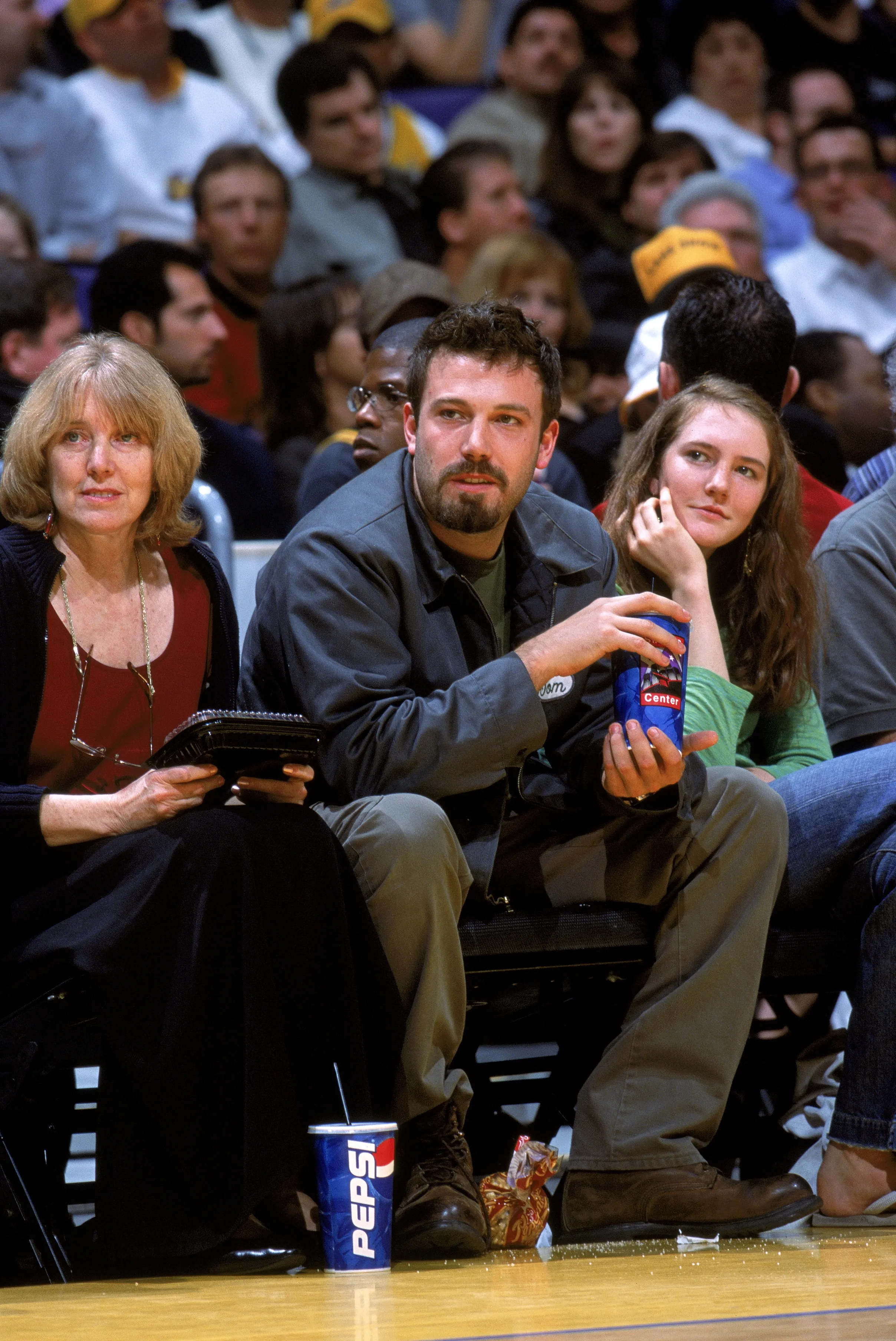 Ben Affleck and his mother Chris Affleck sitting courtside at an NBA game.