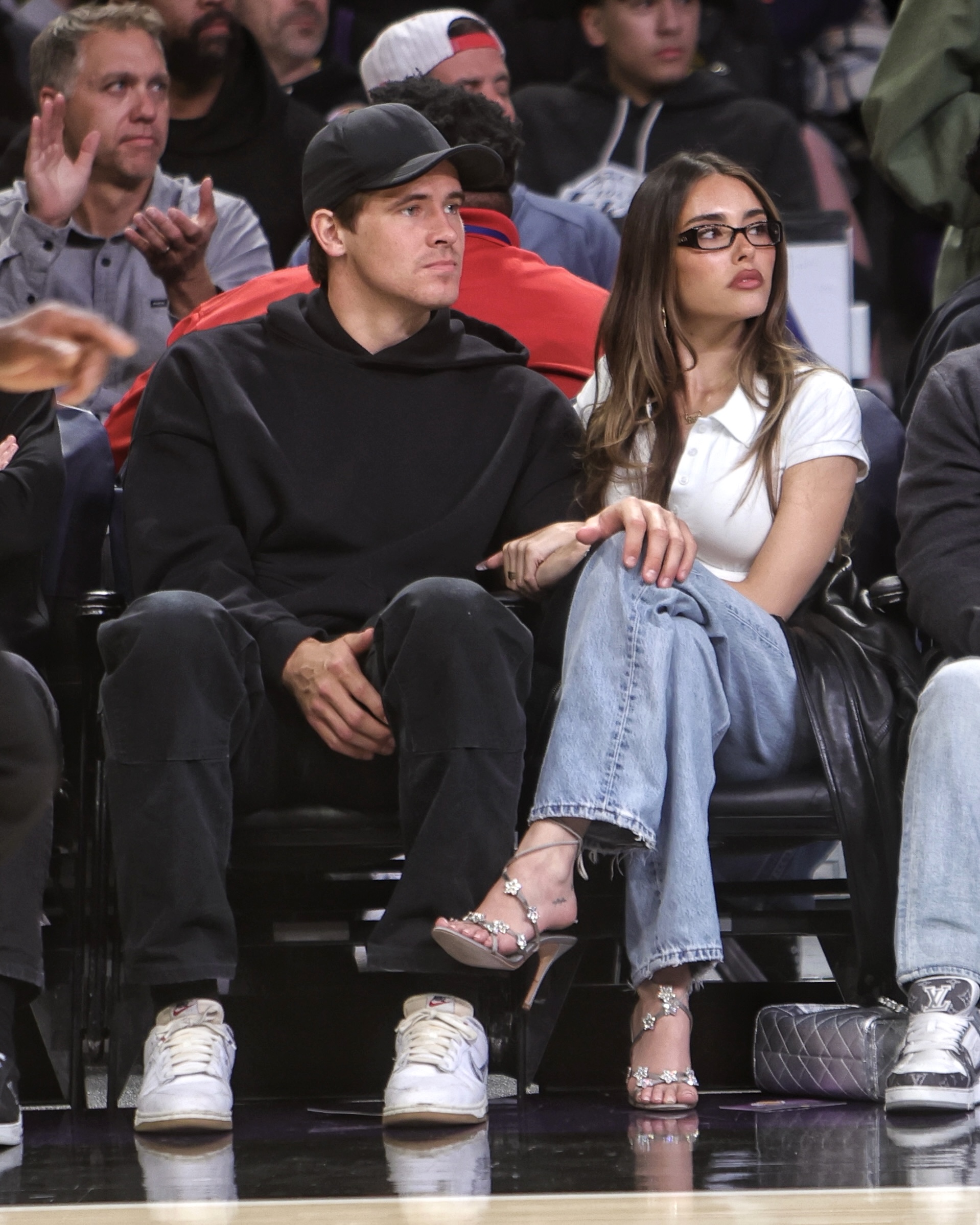 Madison Beer and Justin Herbert attending a basketball game.