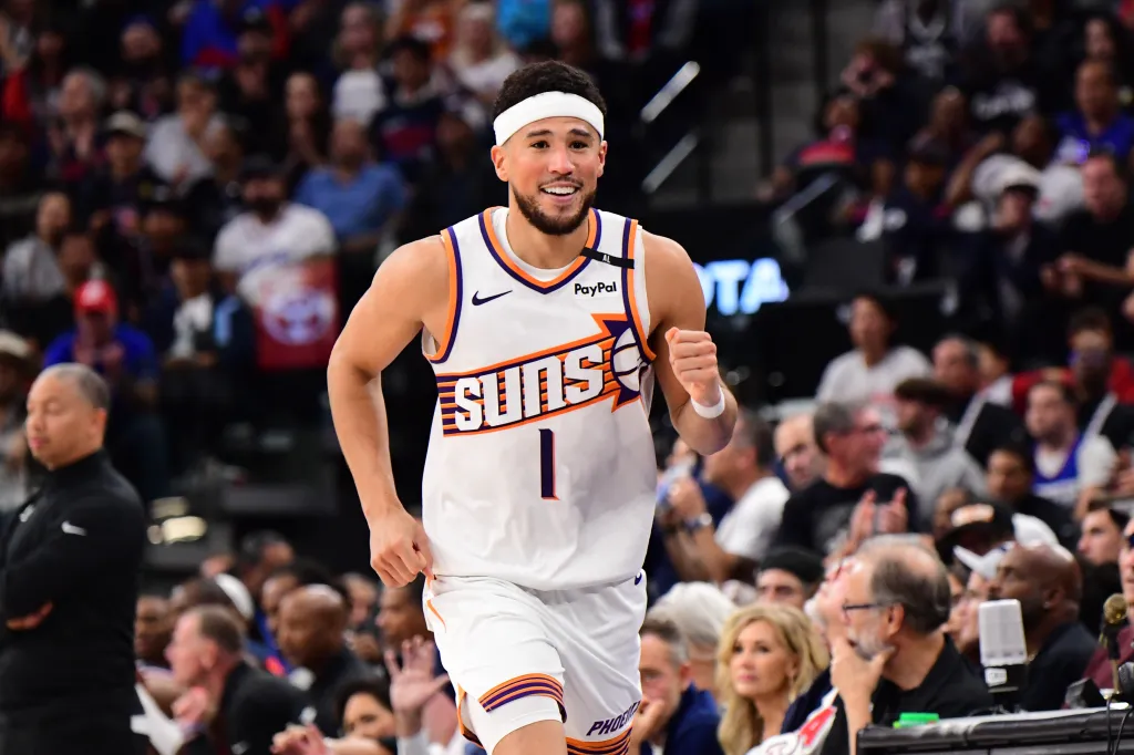 Devin Booker of the Phoenix Suns smiles during a basketball game.