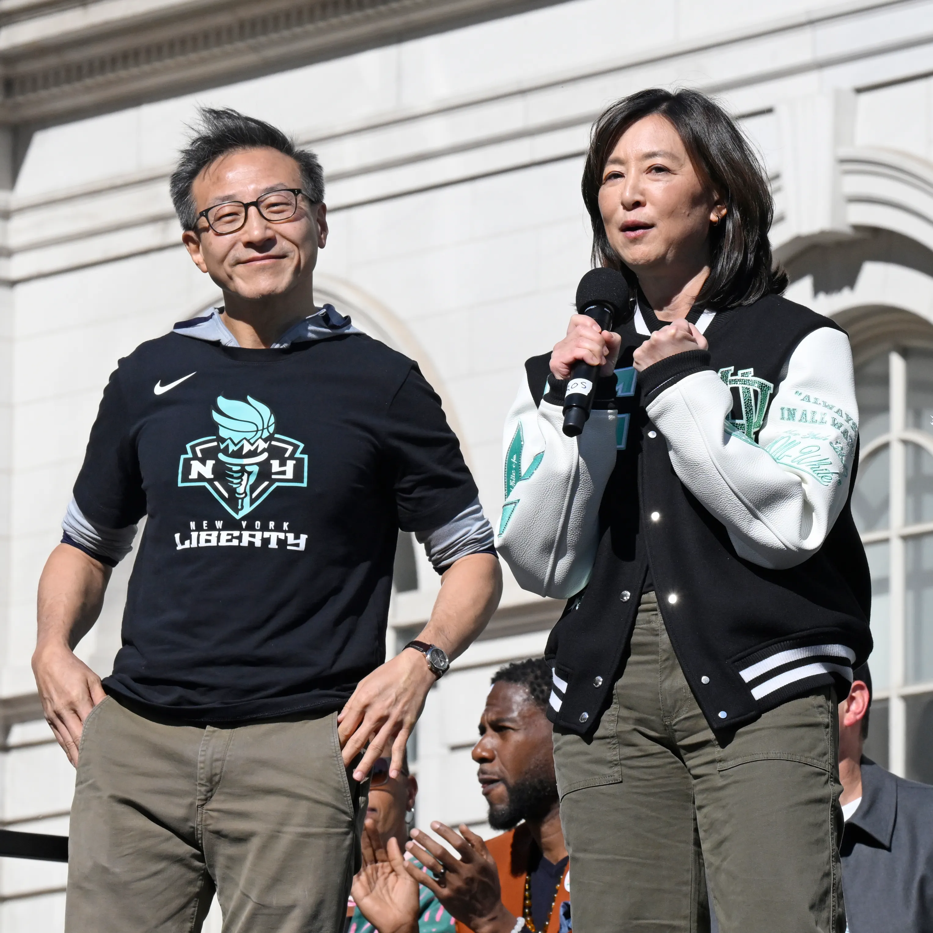 Joe Tsai and Clara Wu Tsai speaking at the 2024 New York Liberty Ticker Tape Victory Parade and Rally.