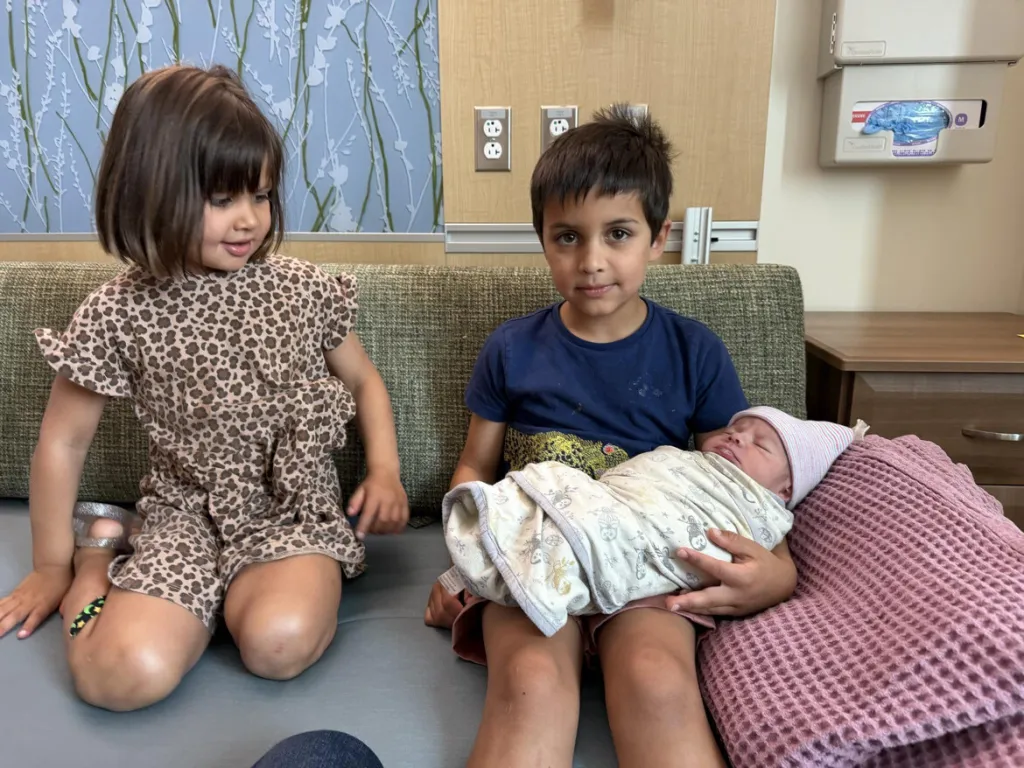 Two of three Vance siblings welcome their fourth sibling, Alec Neel