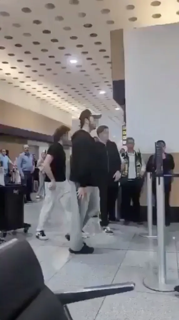 A video grab of passengers fighting with airport staff after being removed from a plane.