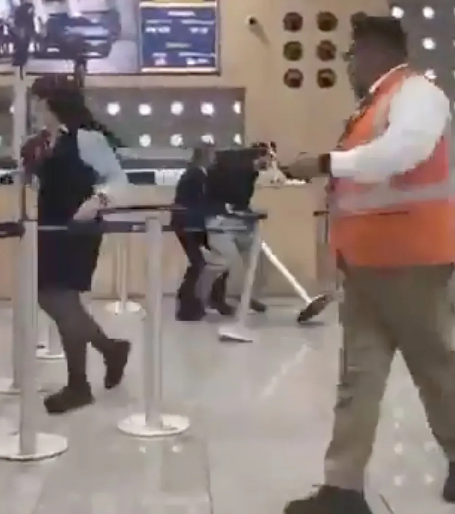 Video grab of airport staff and passengers involved in a chaotic brawl.
