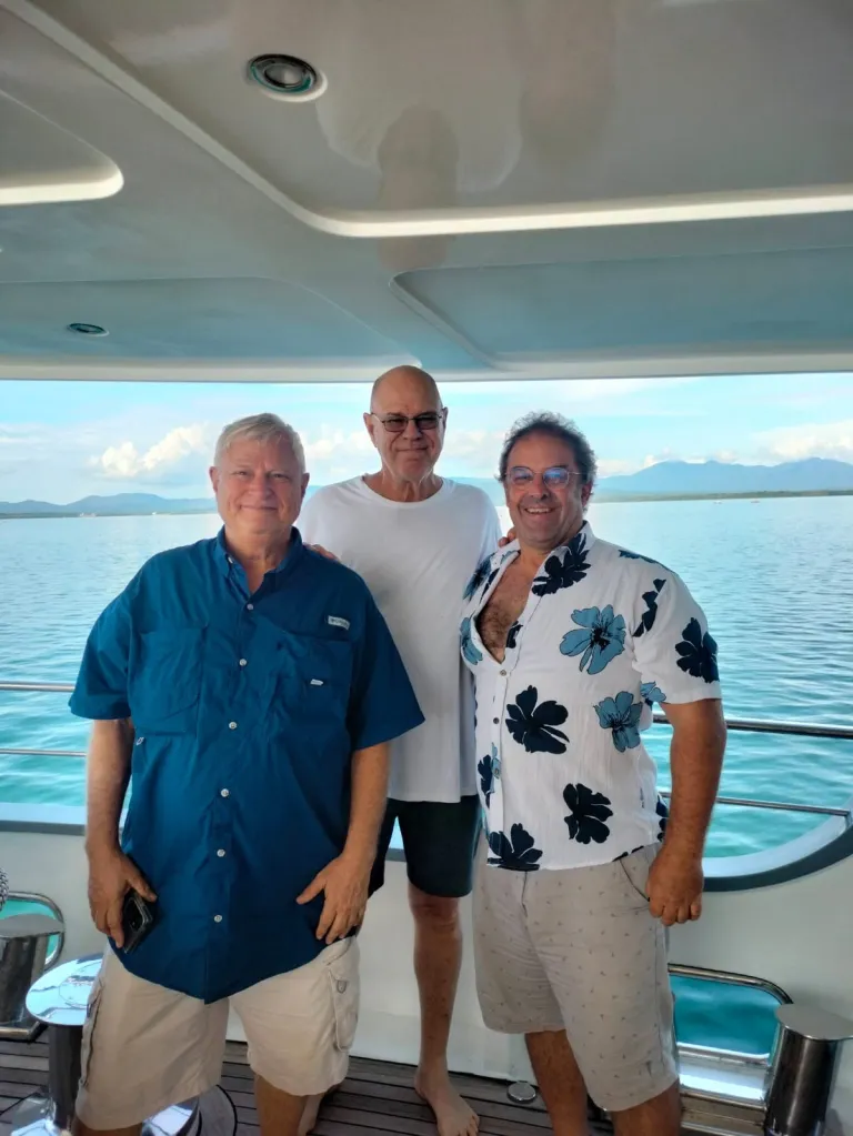 Kent Carpenter (left) and two other men smiling on a boat.