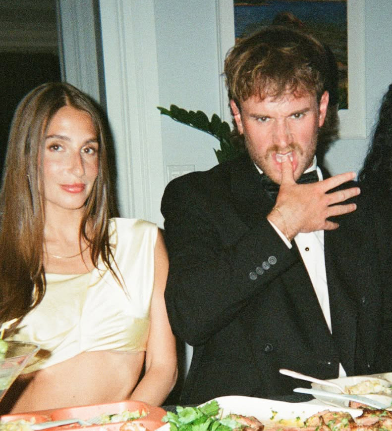 West Wilson in a tuxedo and Amanda Batula in a light yellow top at a dinner.