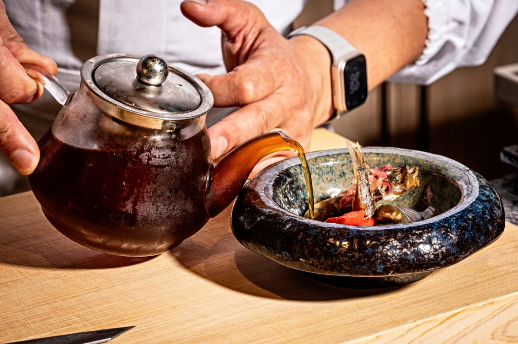 Willowleaf fish served alongside sweet pepper, eggplant, and pickled ginger flower in a soy dashi at Omakase at Barracks Row Restaurant.