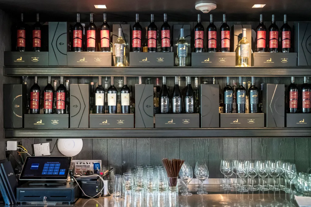 Wine bottles from Robert Mondavi Winery and VII(N) The Seventh Estate, including Ode to Soul, displayed at a bar.