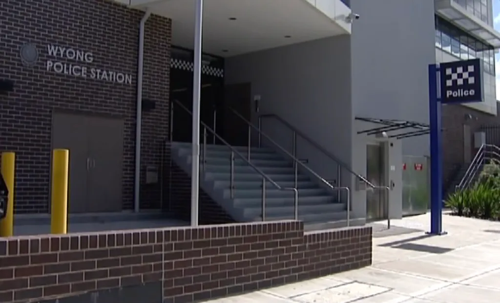 The exterior of the Wyong Police Station, with a brick facade and a blue "Police" sign.