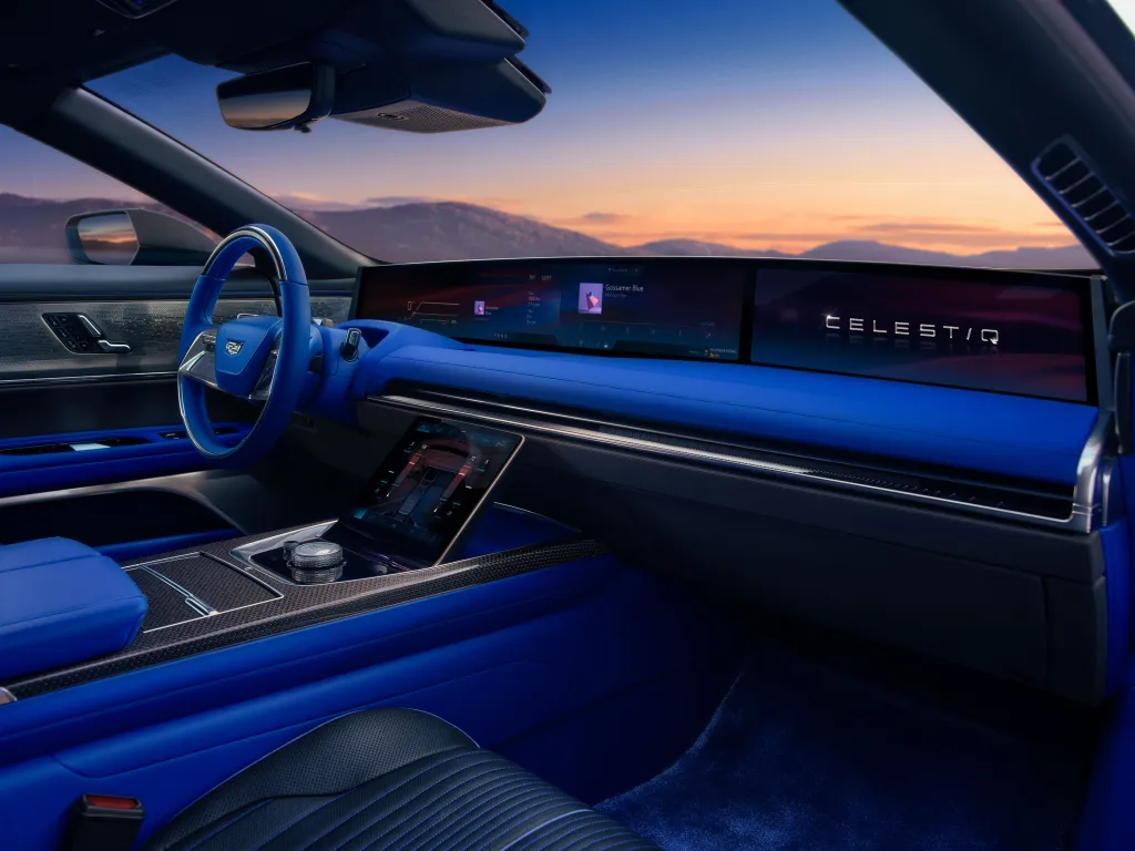The interior of the Cadillac CELESTIQ with blue and black upholstery and a panoramic screen across the dashboard.