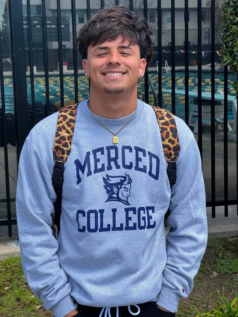 Bobby Criado wearing a grey "Merced College" sweatshirt.