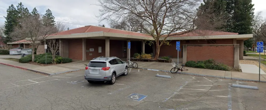Butte County Library in Chico, with a silver SUV parked in a handicap space.