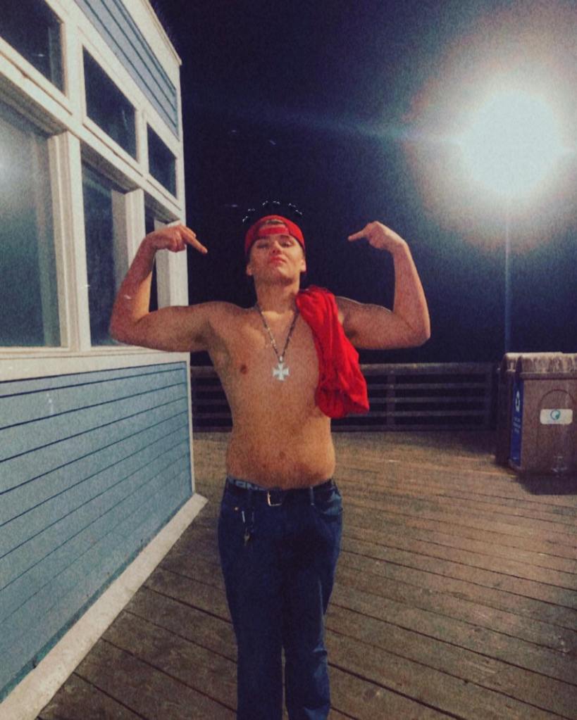 Austin Yoshe flexing his arm muscles.