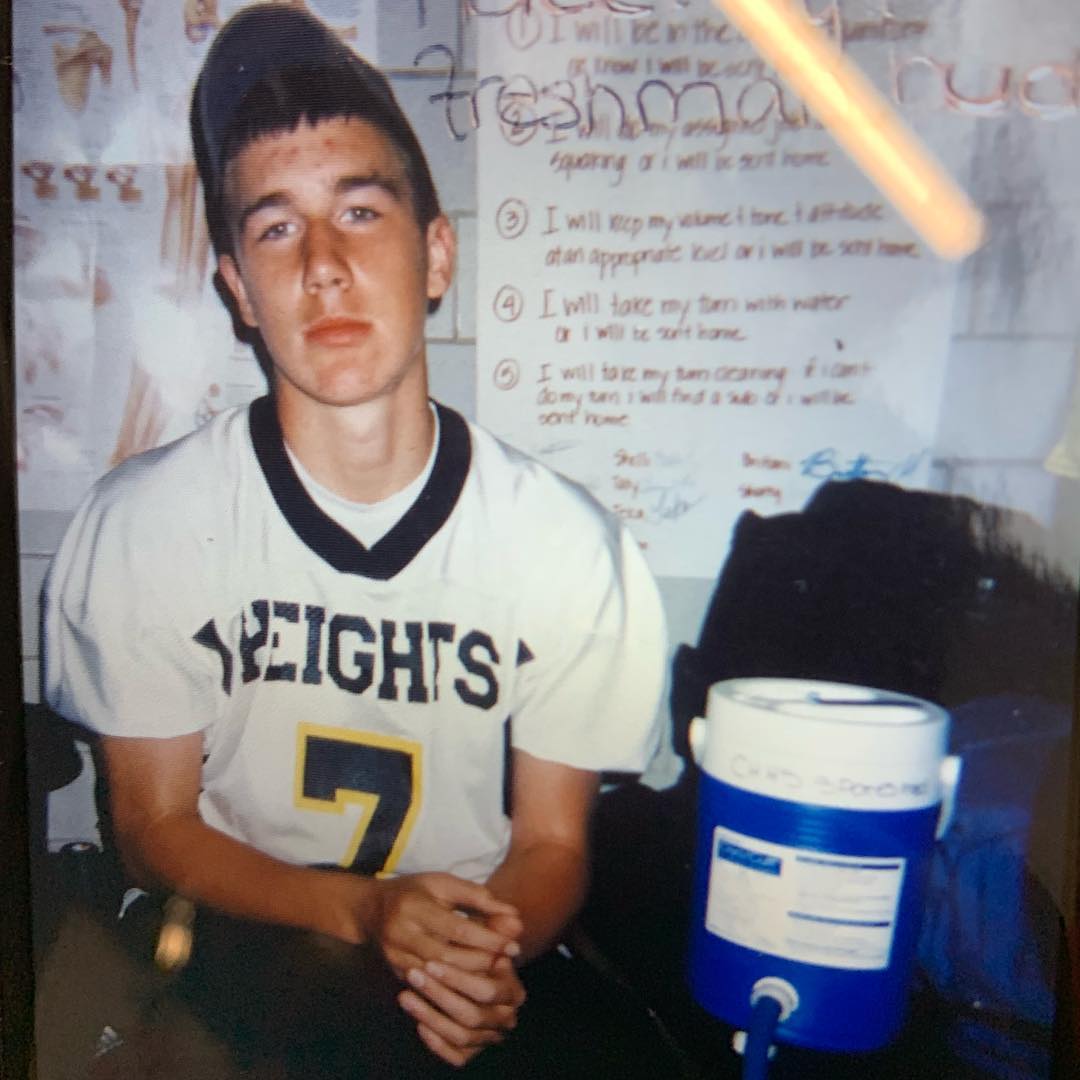 Travis Kelce in a white Heights High School football jersey.