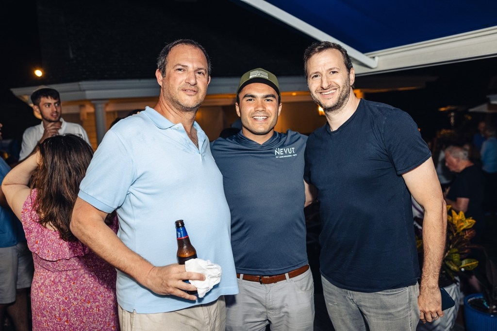 Three men, including Michael and David Shabsel, pose for a photo with a Nevut Lone Soldier Veteran.
