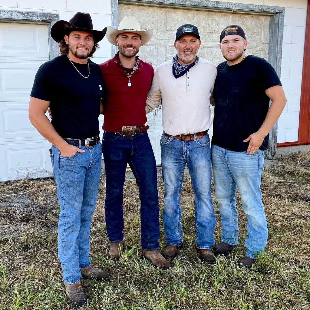 Steven McBee Sr. and his three sons posing together.