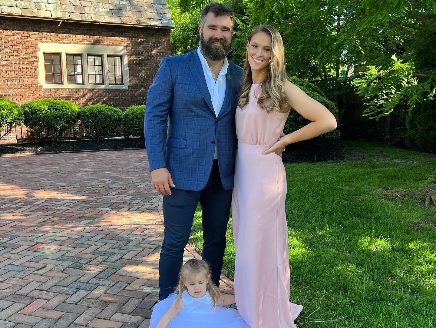 Kylie Kelce, Jason Kelce, and their daughter pose for a photo.